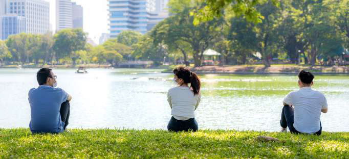 young people keeping segurity distance in the park